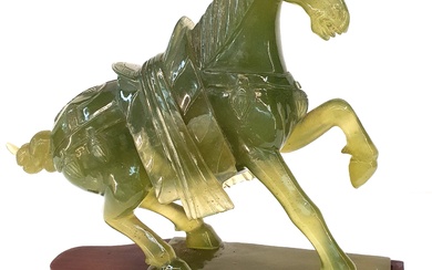 A CHINESE CARVED GREEN HARDSTONE TANG HORSE
