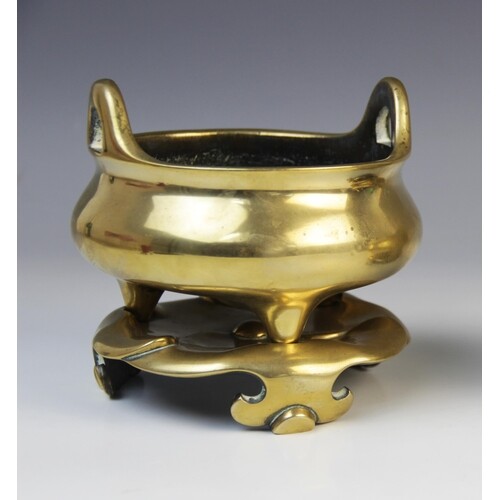 A Chinese bronze censer and stand, late 19th century, the ce...