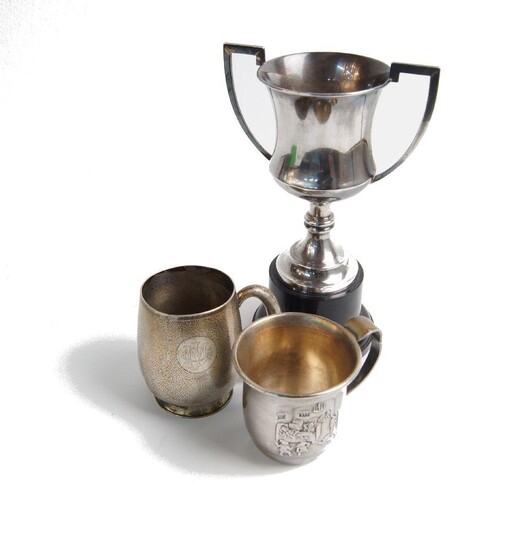 A Chinese christening cup, the base stamped Tuck Chang, assumed silver, the textured, monogrammed body to a rounded handle, 7cm high, together with a silver plated cup and a twin-handled trophy cup, stamped silver, mounted on a detachable pedestal...