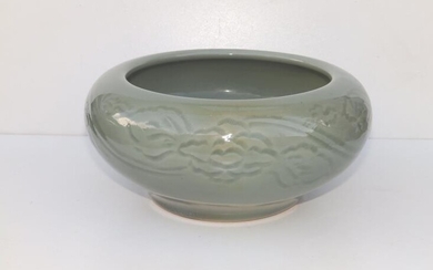 A Chinese celadon glazed porcelain bowl, the thickly potted...
