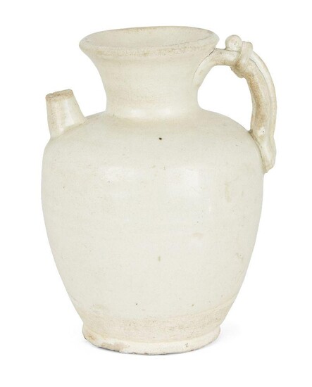 A Chinese white-glazed ewer, Tang dynasty, the bulbous body applied with a rope-twist handle opposite a short spout, covered with a milky-white glaze that falls short of the foot. 15.5cm high