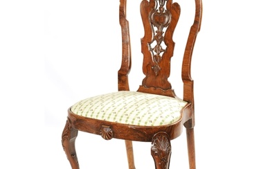 A GEORGE I FIGURED WALNUT SIDE CHAIR with leaf carved and sc...