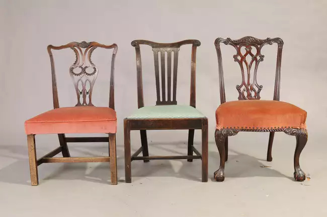A George III oak side chair, last quarter 18th century, and two English mahogany side chairs,...