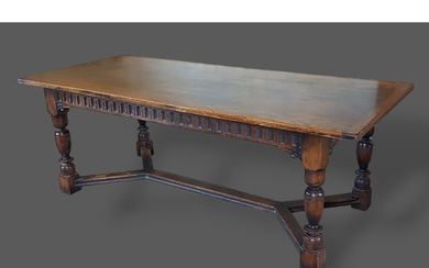 A Jacobean style oak refectory dining table, the plank top a...