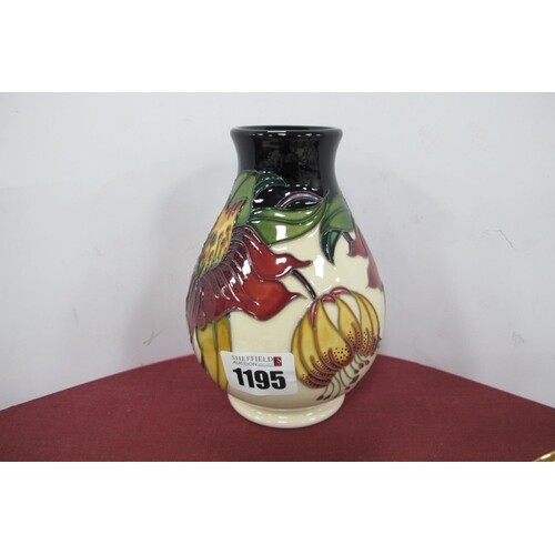 A Moorcroft Pottery Vase, painted in the 'Anna Lily' pattern...