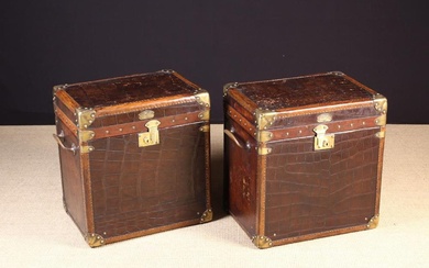 A Pair of Leather Bound Crocodile-skin Travelling Trunks. The rectangular lids clad in dark brown 'c