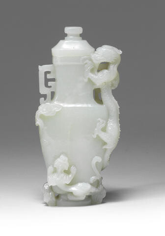 A RARE VERY PALE GREEN JADE 'DRAGON AND YOUNG' VASE AND COVER