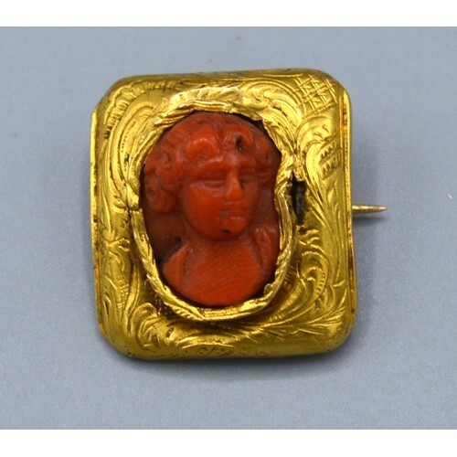 A Small Rectangular Brooch the carved coral centre in the fo...