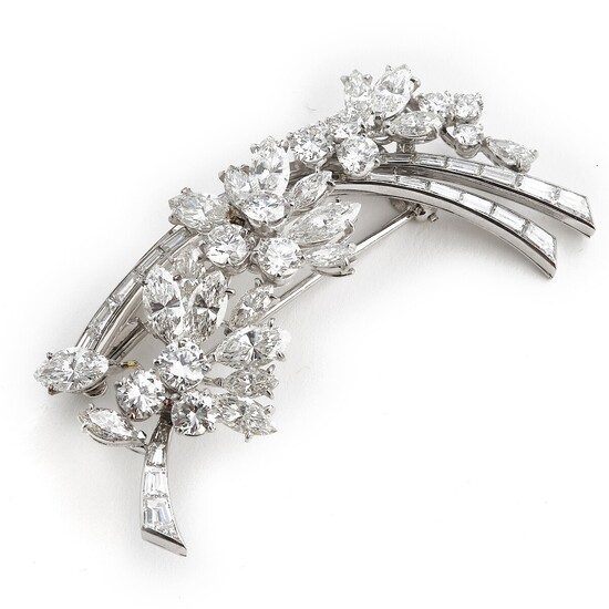A diamond brooch in the shape of a flower branch set with numerous brilliant and baguette-cut diamonds weighing a total of app. 12.41 ct., mounted in platinum.