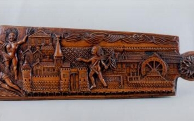 A fine elaborately carved wood tobacco rasp decorated