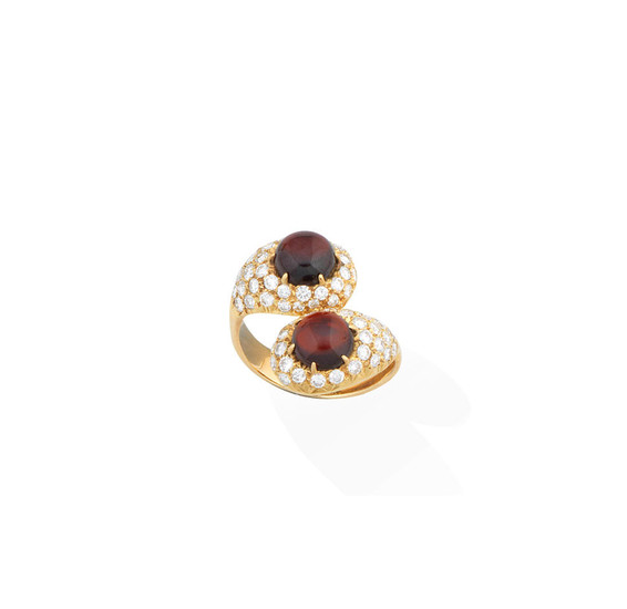 A garnet and diamond crossover ring