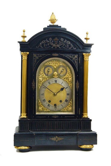 A late Victorian ebonised and gilt-brass mounted chiming bracket clock, late 19th century, the architectural case with gilt-bronze finials above arched cornice with scrolling brass inlay over twin Corinthian columns and pierced gilt-brass side...