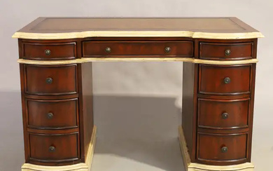 A modern mahogany kneehole desk, George III style, parcel cream painted, tooled...