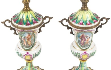 A pair of French porcelain gilt metal mounted mantel urns