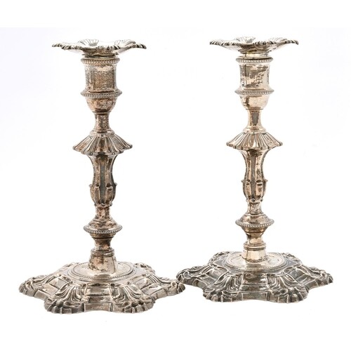A pair of George III cast silver candlesticks, with shells, ...