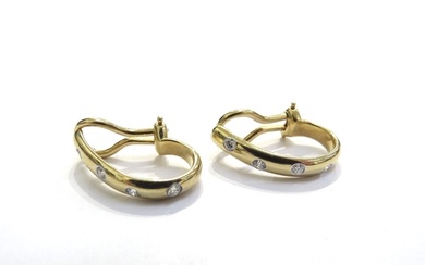 A pair of Tiffany and Co yellow gold earrings each set with ...