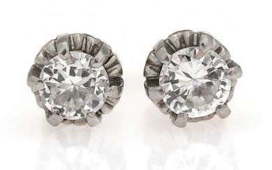SOLD. A pair of diamond ear screws each set with a brilliant-cut diamond weighing a...