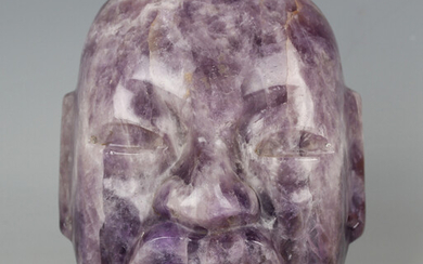 A pre-Columbian Olmec style finely carved amethyst quartz mask, probably 800-400 BC, with pierced ho