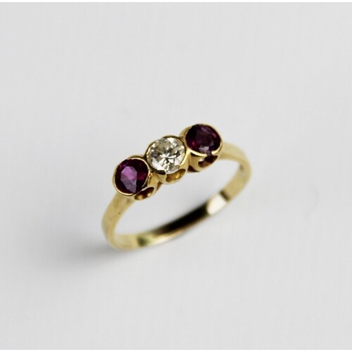 A ruby and diamond three-stone ring, comprising a central br...