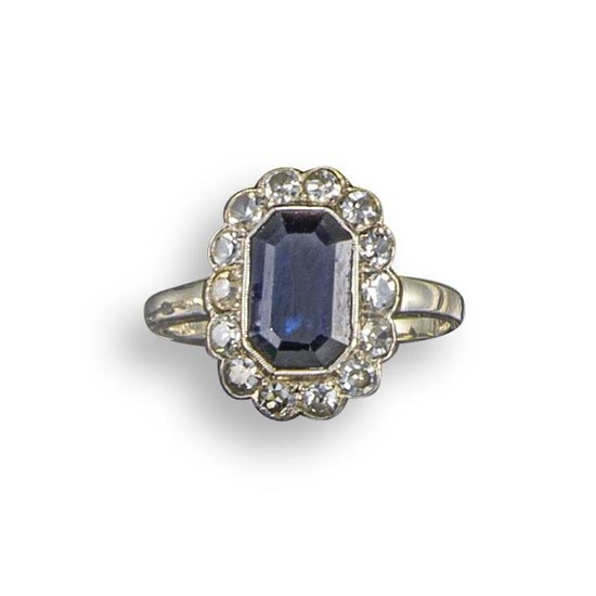 A sapphire and diamond cluster ring, the emerald-cut...