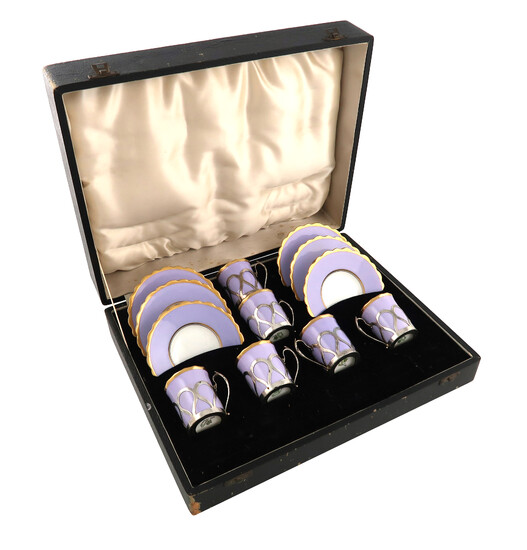 A set of six silver-mounted ceramic coffee cups and saucers