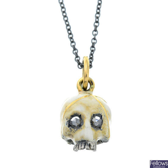 A silver enamel skull pendant with 18ct gold bail and rose-cut diamond eyes.