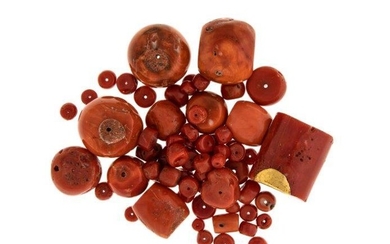 A small collection of coral beads, comprising four large barrel shaped coral corallium rubrum beads and various smaller coral beads