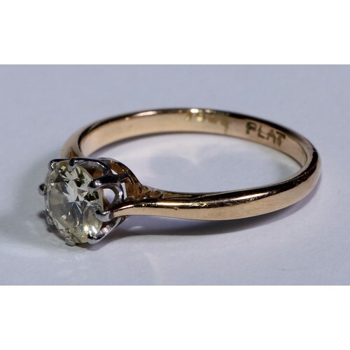 An 18ct gold diamond solitaire ring, platinum bezel, the bri...