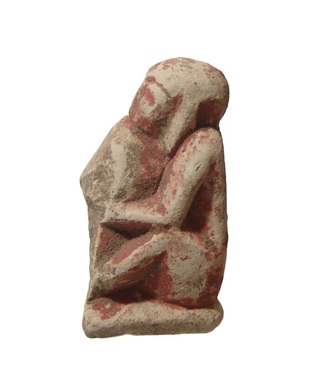 An Egyptian limestone figure of a seated figure