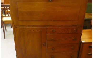 An Ercol stained elm cabinet, incorporating a fall front, ov...
