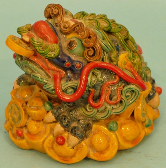 An Oriental Glazed Earthenware Figure of an animal on multic...