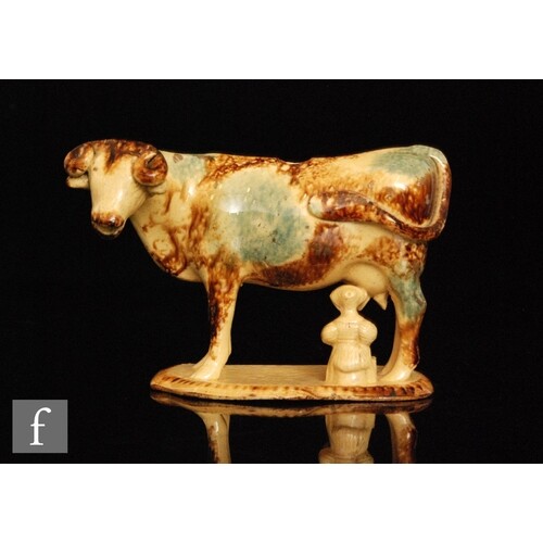 An early 19th Century cow creamer with a milk maid and pail ...