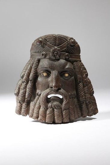 An early 19th century carved wood mask in the mann…