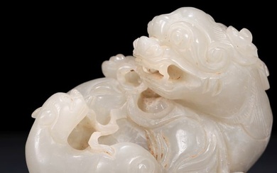 An exquisite white jade lion ornament