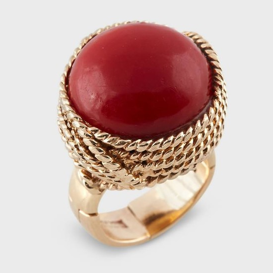 An oxblood coral and fourteen karat gold ring