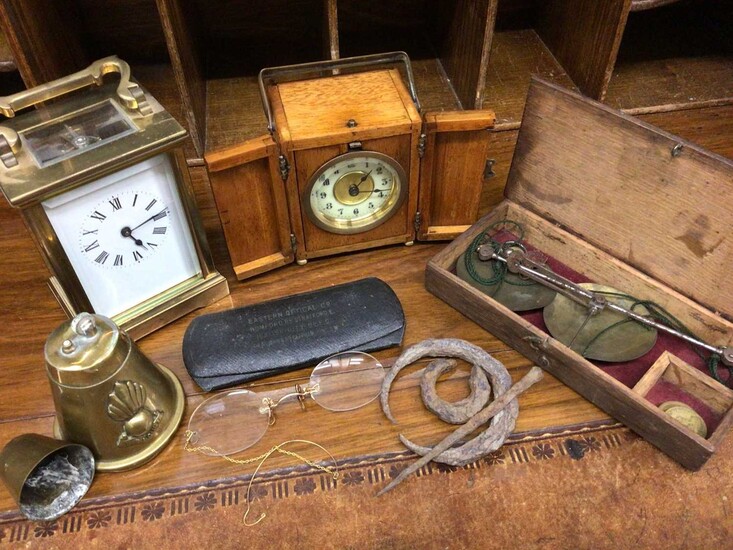 Brass cased carriage clock, one other timepiece in wooden case, set scales, pair antique spectacles, trench art lighter and artefacts