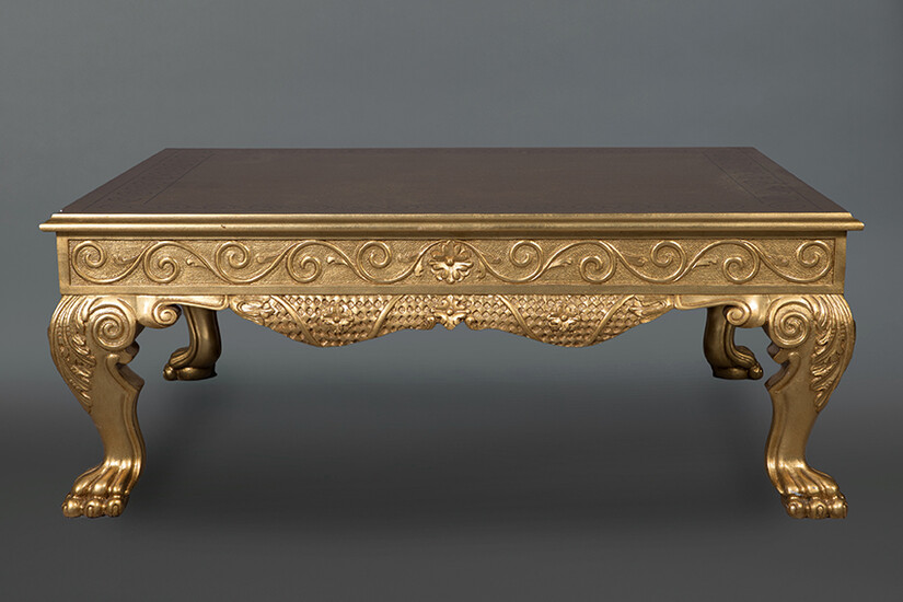 Empire style coffee table in carved and gilded wood with relief decoration of vegetable elements. On claw feet. Size: 48x102x122cm. Exit: 10000uros. (166.386 Ptas.)