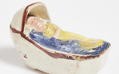 English Prattware Pottery Model of a Baby in a Cradle, early 19th century