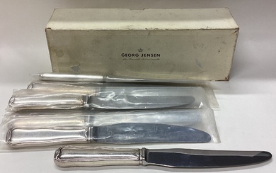 GEORG JENSEN: A rare boxed set of eight silver knives.