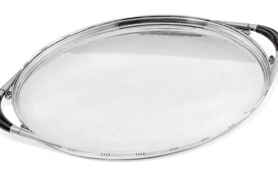 Johan Rohde: A large oval sterling silver serving tray with hammered surface. Handles of carved ebony. L. 60 cm.