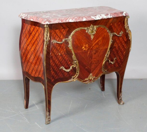 Louis XV style chest of drawers with curved front and side in place and marquetry of crosses and flowered foliage in a cartouche and beautiful bronze ornamentation. It opens with two drawers without crosspiece, curved legs. Red Breche marble top...