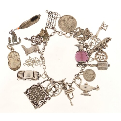 Silver charm bracelet with a large selection of mostly silve...