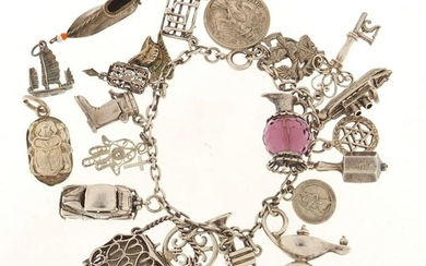 Silver charm bracelet with a large selection of mostly