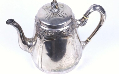 Silver teapot with embossed and chiselled Art Nouveau style decoration.