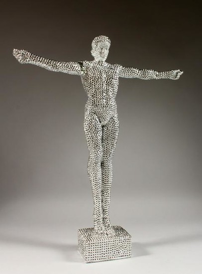THE GLITTER MAN, a standing figure with arms