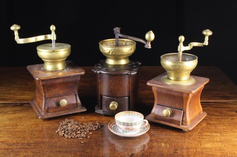Three Vintage Brass Coffee Grinders; each having a wooden box form base with brass handled drawer.