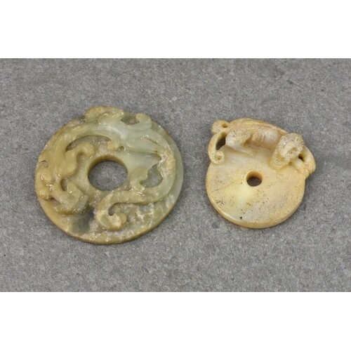Two Chinese carved jade Pi discs, probably 19th century, the...