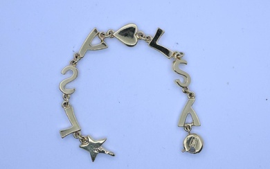 Yves SAINT LAURENT Bracelet monogramme en métal doré. Long. 19 cm ***** Porter enchère équivaut...
