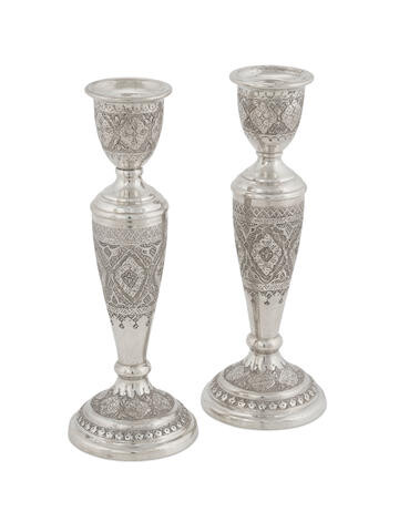 A pair of Persian silver candlesticks