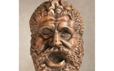 A sculpted and stained beechwood mask, loosely in the manner of the Farnese Hercules